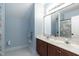 Bathroom with dual sinks, vanity, large mirror and colorful shower curtain at 9225 Palm Bay Cir, Raleigh, NC 27617