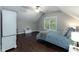 Bedroom with hardwood floors, neutral walls, sloped ceilings, and great natural light at 9225 Palm Bay Cir, Raleigh, NC 27617