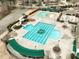 Aerial view of a community pool with various water features, slides, and shaded lounging areas at 9225 Palm Bay Cir, Raleigh, NC 27617