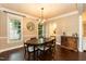 Elegant dining room featuring hardwood floors, modern chandelier, and a wine storage cabinet at 9225 Palm Bay Cir, Raleigh, NC 27617