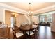 Elegant dining room featuring hardwood floors, modern chandelier, and flows into the living room at 9225 Palm Bay Cir, Raleigh, NC 27617