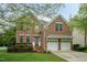 Charming brick two-story home featuring an attached two-car garage and manicured landscaping at 9225 Palm Bay Cir, Raleigh, NC 27617