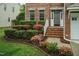 Close up of a brick front porch with beautiful flowering bushes at 9225 Palm Bay Cir, Raleigh, NC 27617