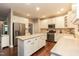 Bright kitchen featuring white cabinetry, stainless steel appliances, and center island at 9225 Palm Bay Cir, Raleigh, NC 27617