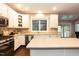 Bright kitchen with an island, white cabinets, and stainless steel appliances at 9225 Palm Bay Cir, Raleigh, NC 27617