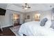 Comfortable main bedroom with trey ceiling, ceiling fan, and doorway to bathroom at 9225 Palm Bay Cir, Raleigh, NC 27617