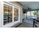 Cozy sunroom featuring a ceiling fan, access to backyard, and views into the bright kitchen at 9225 Palm Bay Cir, Raleigh, NC 27617