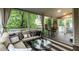 Inviting sunroom with comfortable seating, stylish decor, and a view of the landscaped outdoors at 9225 Palm Bay Cir, Raleigh, NC 27617