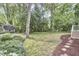 Picturesque backyard featuring a grassy area, shade trees, and thoughtful landscaping for outdoor enjoyment at 1005 W Lenoir St, Raleigh, NC 27603