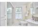 Bright bathroom featuring a glass shower, vanity with sink, and tiled floors at 1005 W Lenoir St, Raleigh, NC 27603