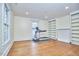 Spacious bonus room with built in bookshelves, hardwood floors, and a treadmill at 1005 W Lenoir St, Raleigh, NC 27603