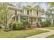 Attractive two-story home with a spacious front porch surrounded by mature trees and landscaping at 1005 W Lenoir St, Raleigh, NC 27603