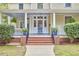 Welcoming front porch with classic columns and meticulously maintained landscaping, creating a warm entry at 1005 W Lenoir St, Raleigh, NC 27603