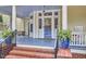 Charming front porch featuring classic columns and a swing, ideal for enjoying outdoor living at 1005 W Lenoir St, Raleigh, NC 27603