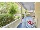 Inviting front porch featuring classic white railings and columns, providing a comfortable space for outdoor relaxation at 1005 W Lenoir St, Raleigh, NC 27603