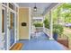 Charming front porch with classic features like a rocking chair and 'Welcome' mat for a warm greeting at 1005 W Lenoir St, Raleigh, NC 27603