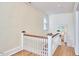 Upstairs hallway with a view into a bathroom and natural light at 1005 W Lenoir St, Raleigh, NC 27603