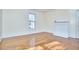 Room with hardwood floors, a window and a non-functional fireplace at 1005 W Lenoir St, Raleigh, NC 27603