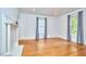 Light filled living room with hardwood floors, fireplace and three windows with curtains at 1005 W Lenoir St, Raleigh, NC 27603