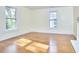 Sunlit room with hardwood floors and large windows providing natural light and a view of the outdoors at 1005 W Lenoir St, Raleigh, NC 27603