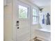 Inviting mudroom with coat rack, bench storage, and bright window at 1005 W Lenoir St, Raleigh, NC 27603