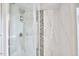 Modern shower boasts marble tiles, sleek fixtures, and glass door at 1005 W Lenoir St, Raleigh, NC 27603