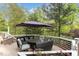 Relax on this expansive back deck with comfortable outdoor seating and flowering plants at 1011 Wood Sage Dr, Chapel Hill, NC 27516