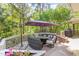 This is a spacious back deck with comfortable outdoor seating, plants and a grill at 1011 Wood Sage Dr, Chapel Hill, NC 27516