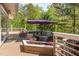 This expansive back deck has comfortable outdoor seating and flowering plants at 1011 Wood Sage Dr, Chapel Hill, NC 27516