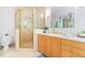 Elegant bathroom with a glass-enclosed shower, wood cabinets, and modern fixtures creating a spa-like experience at 1011 Wood Sage Dr, Chapel Hill, NC 27516