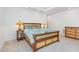 Comfortable bedroom featuring a custom wooden bed frame, coordinating nightstand, and a dresser for ample storage at 1011 Wood Sage Dr, Chapel Hill, NC 27516
