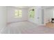 Bright bedroom with leafy views from the windows, and a frosted glass paneled door at 1011 Wood Sage Dr, Chapel Hill, NC 27516