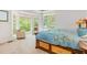 Inviting bedroom with large windows, comfortable seating, and a stylish wooden bed with colorful bedding at 1011 Wood Sage Dr, Chapel Hill, NC 27516