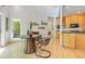 Inviting dining area with a modern table, natural light, and seamless flow into the adjacent kitchen space at 1011 Wood Sage Dr, Chapel Hill, NC 27516