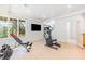 Bright home exercise room with workout equipment and large picture windows at 1011 Wood Sage Dr, Chapel Hill, NC 27516