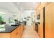 Bright kitchen with modern wood cabinets, sleek black countertops, wood floors and recessed lighting throughout at 1011 Wood Sage Dr, Chapel Hill, NC 27516
