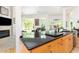 Modern kitchen with dark countertops, wood cabinets and views into the living room and through the large windows at 1011 Wood Sage Dr, Chapel Hill, NC 27516