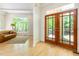 Inviting living room with hardwood floors, French doors, and a large window offering serene views at 1011 Wood Sage Dr, Chapel Hill, NC 27516