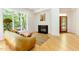 Bright living room with large windows, cozy seating, fireplace and hardwood floors at 1011 Wood Sage Dr, Chapel Hill, NC 27516