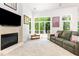 Inviting living room with large windows, a fireplace, and comfortable seating perfect for relaxation and entertainment at 1011 Wood Sage Dr, Chapel Hill, NC 27516