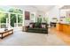 Living room with large windows, sleek flooring, comfortable seating, and an open floor plan for modern living at 1011 Wood Sage Dr, Chapel Hill, NC 27516