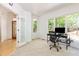 Bright office space with large windows offering serene views of nature and a modern desk setup at 1011 Wood Sage Dr, Chapel Hill, NC 27516