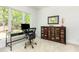 Bright office space with modern desk, large window with natural light, and unique decorative cabinet at 1011 Wood Sage Dr, Chapel Hill, NC 27516