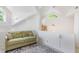 Cozy sitting area with a comfortable green sofa, stylish rug, and bright window at 1011 Wood Sage Dr, Chapel Hill, NC 27516