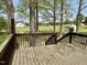 Spacious wooden deck with railing offers a peaceful outdoor retreat overlooking the lawn at 1031 Jackson Royster Rd, Henderson, NC 27537