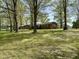 Expansive backyard featuring mature trees and a well-maintained lawn at 1031 Jackson Royster Rd, Henderson, NC 27537