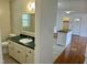 Bathroom showcasing vanity, toilet, and view of the kitchen and entrance, offering a glimpse of the layout at 1031 Jackson Royster Rd, Henderson, NC 27537