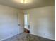 Bedroom with neutral carpet and a door leading to another room, creating a cozy and private space at 1031 Jackson Royster Rd, Henderson, NC 27537