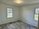 Bright bedroom with two windows bringing in natural light and neutral carpet at 1031 Jackson Royster Rd, Henderson, NC 27537