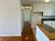Hallway featuring hardwood floors connects the kitchen with a view down the hall to the entry at 1031 Jackson Royster Rd, Henderson, NC 27537
